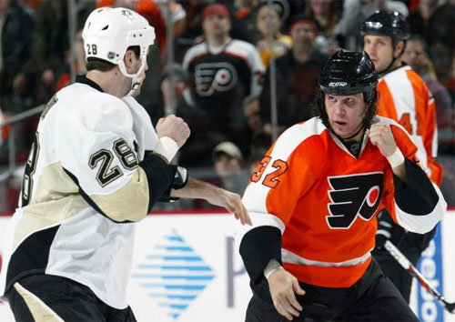 Eric Godard and Riley Cote square off during the 1/13 game