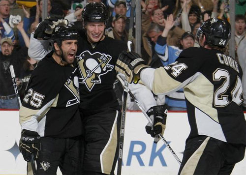 Max Talbot, Jordan Staal, and Matt Cooke celebrate a goal in the third period