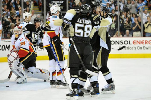 Kris Letang celebrates with Geno and Kunitz after his goal in the first period